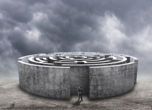 3D circular labyrinth against cloudy sky